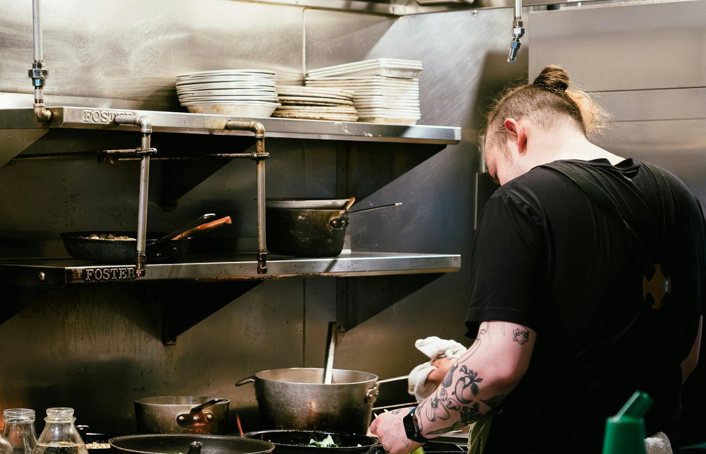 Commercial kitchen exhaust hood above a restaurant cooking line